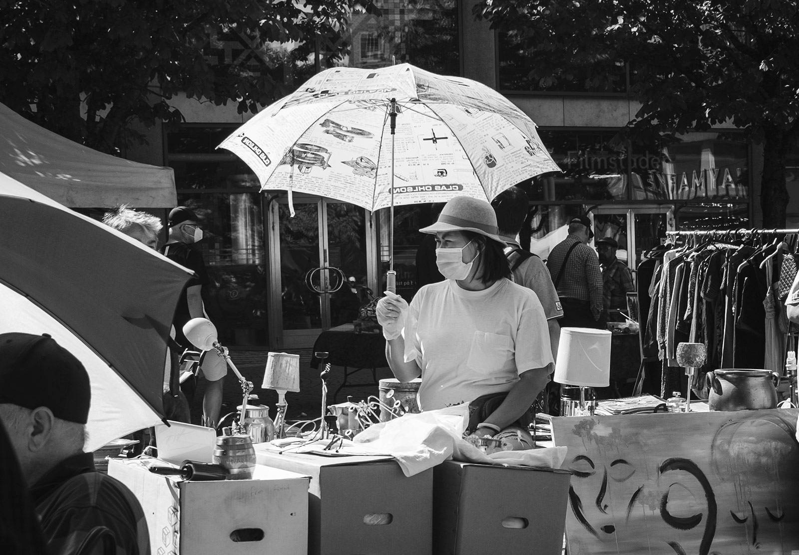 Woman in mask under umbrella