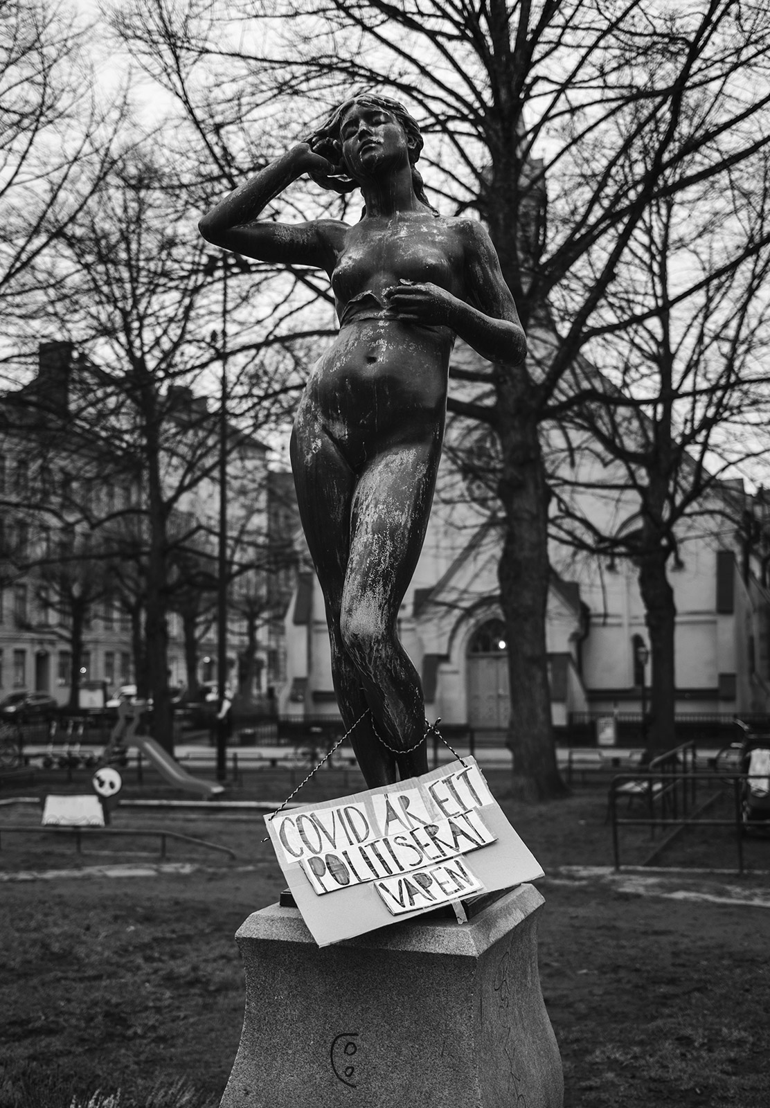 Covid sign on statue