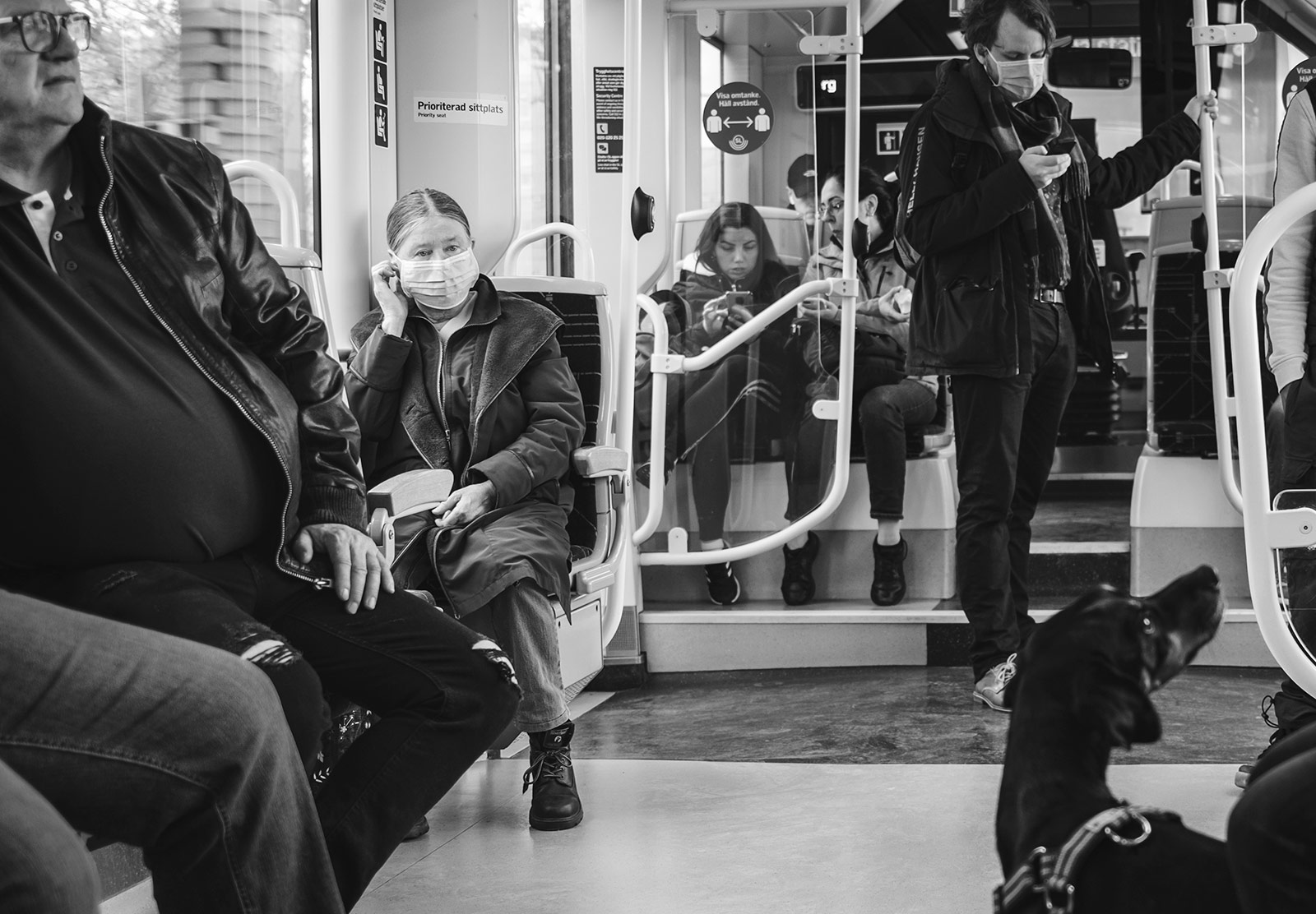 People in masks on a tram