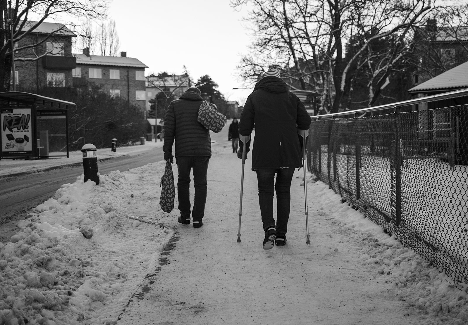 People using crutches in the snow