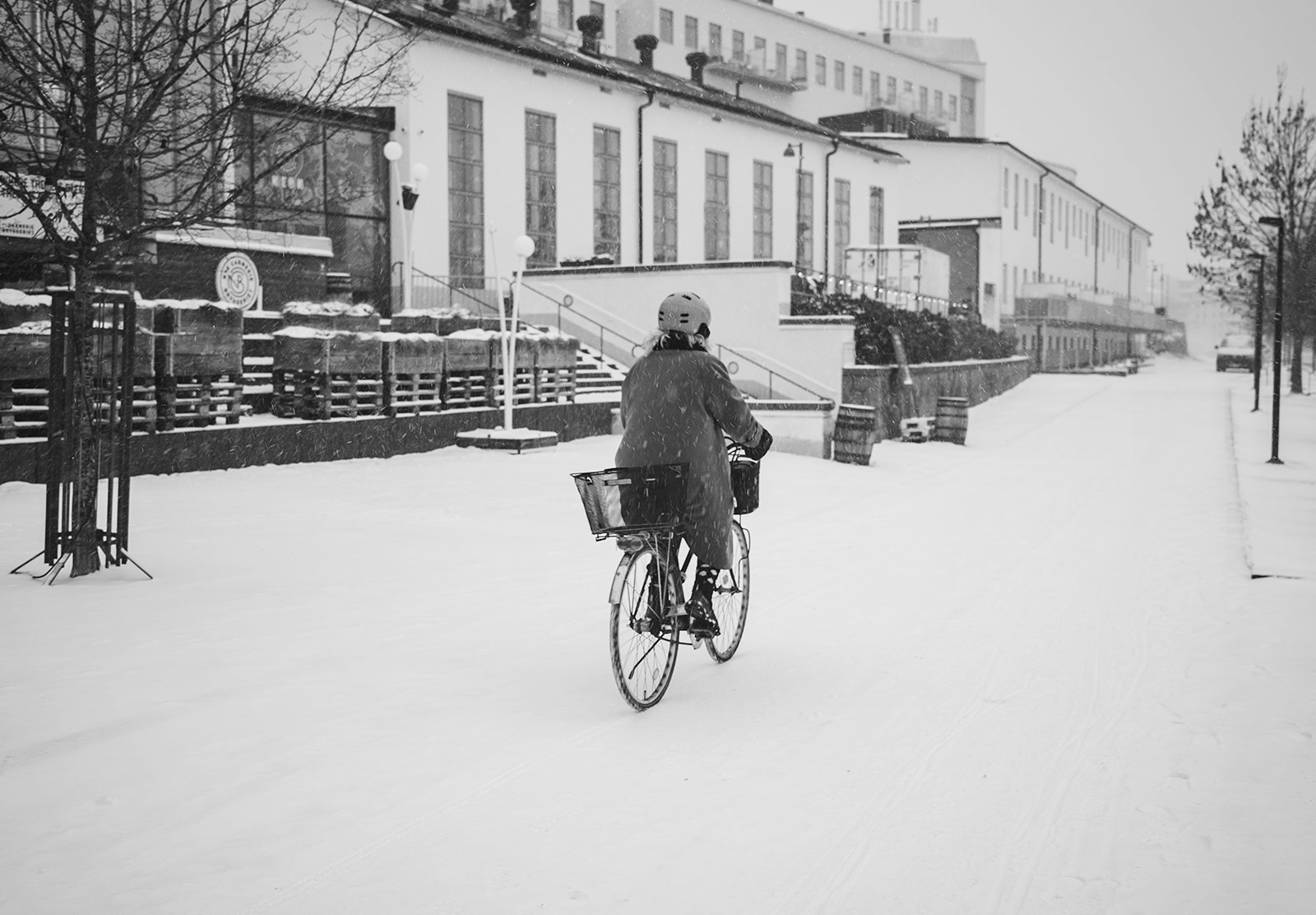 Woman cycling through the snow