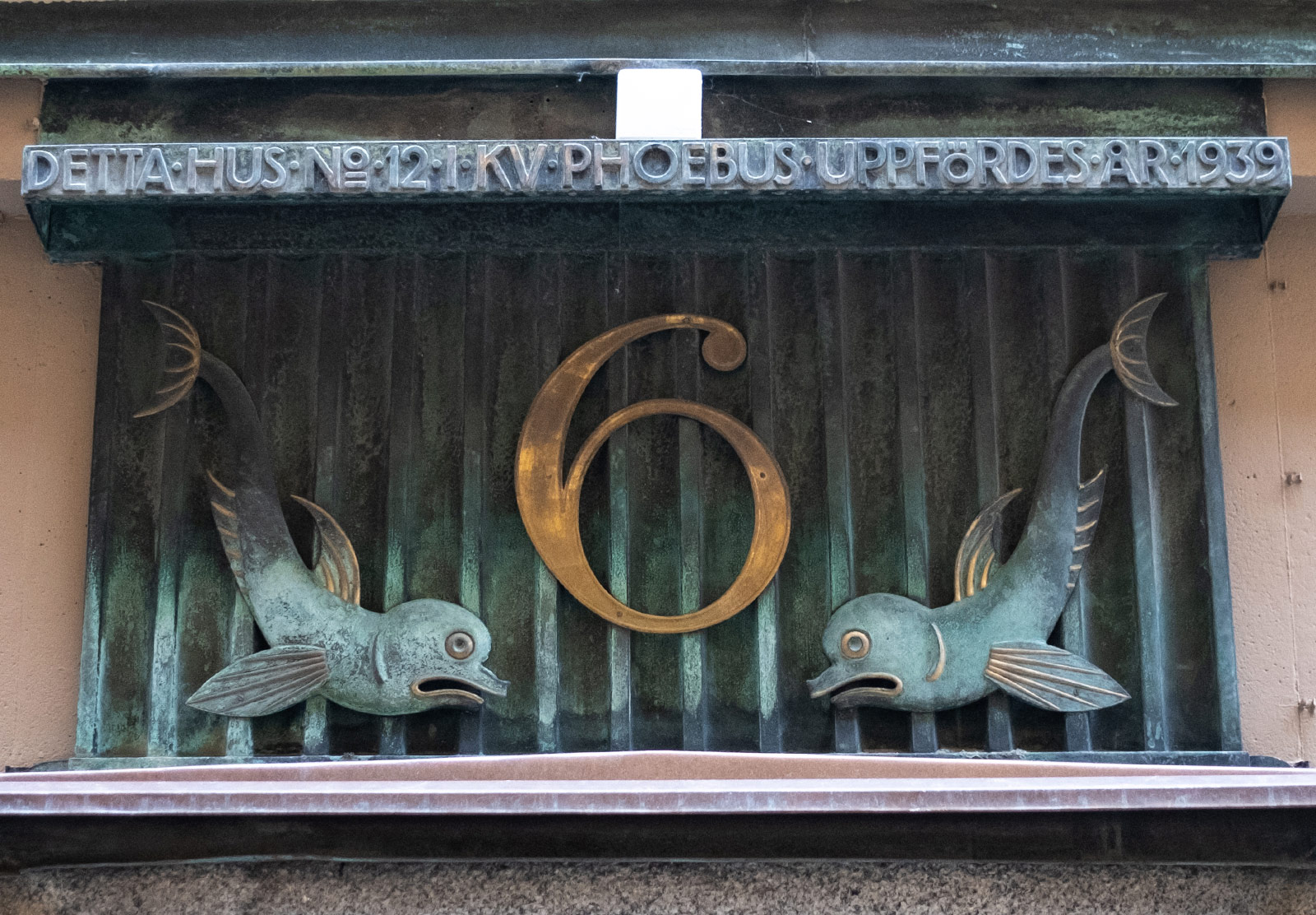 Ornate door sign with two fish