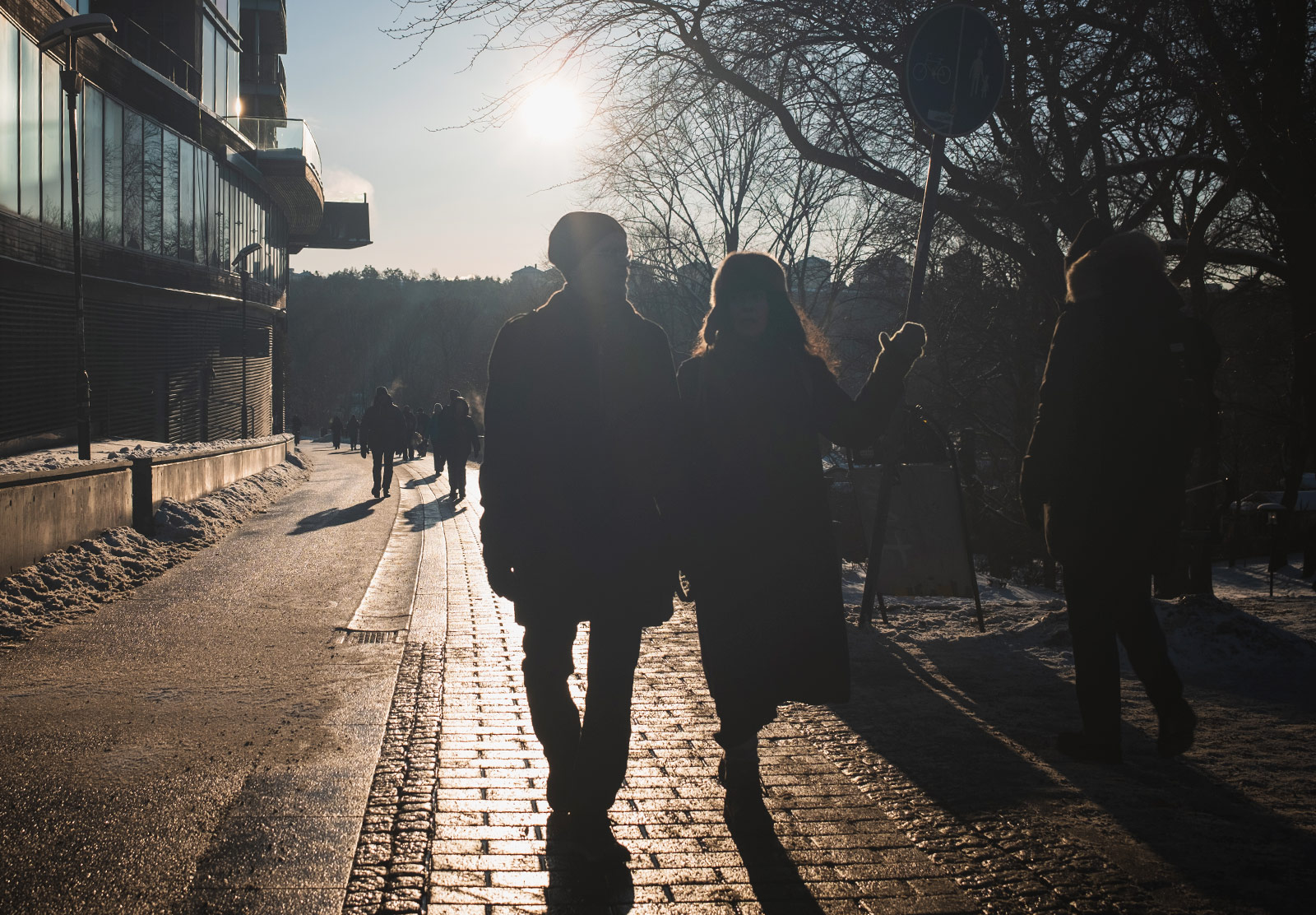 Sun haze behind walking people