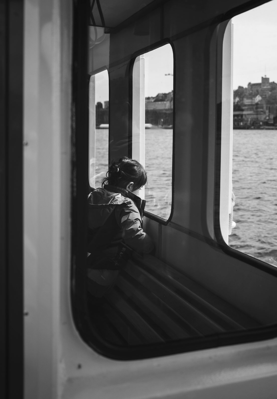 Kid looking out of boat window
