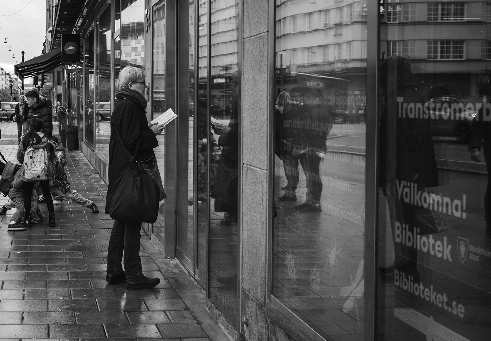 Woman stood at door with book