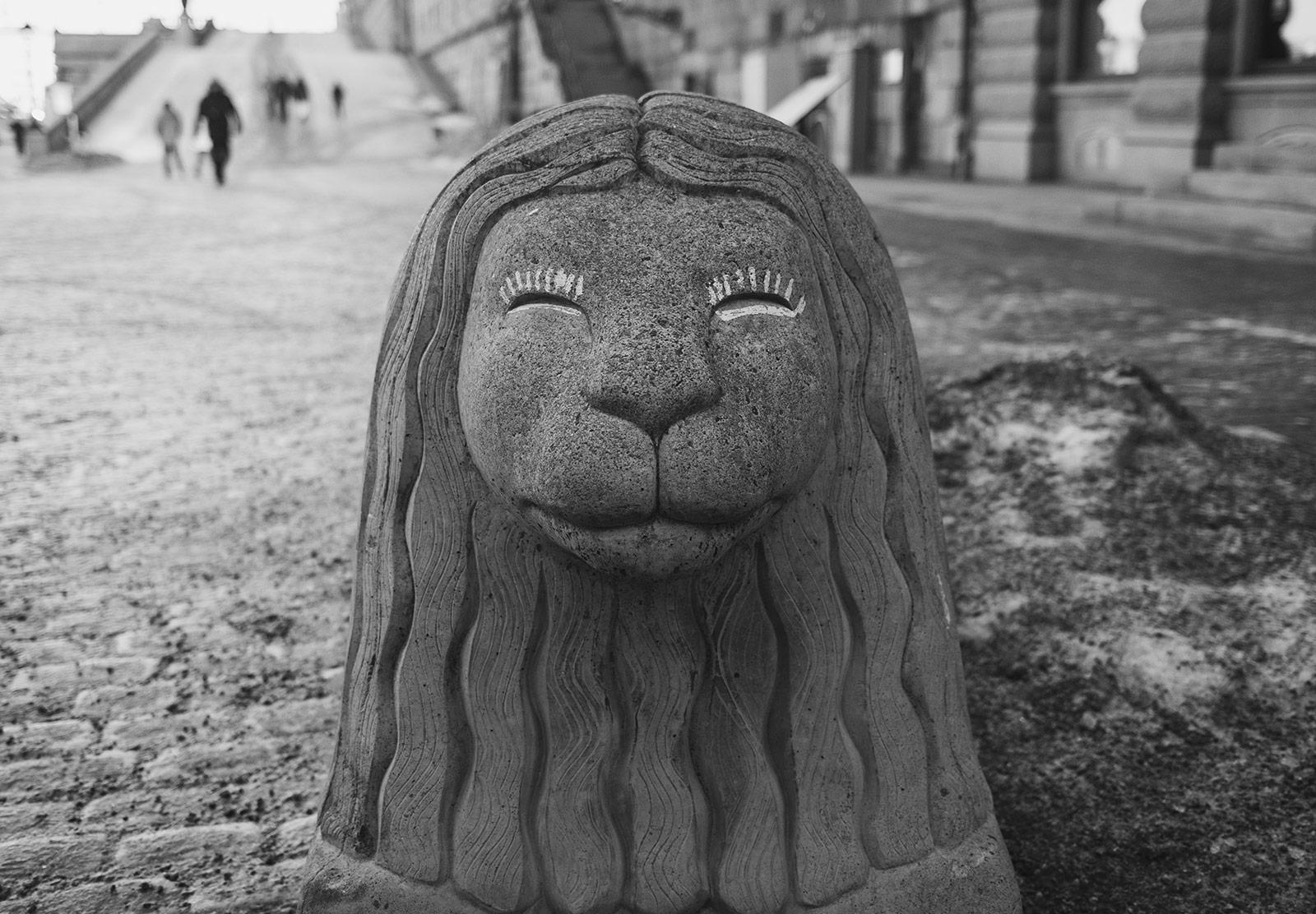Eyelashes drawn on concrete lion