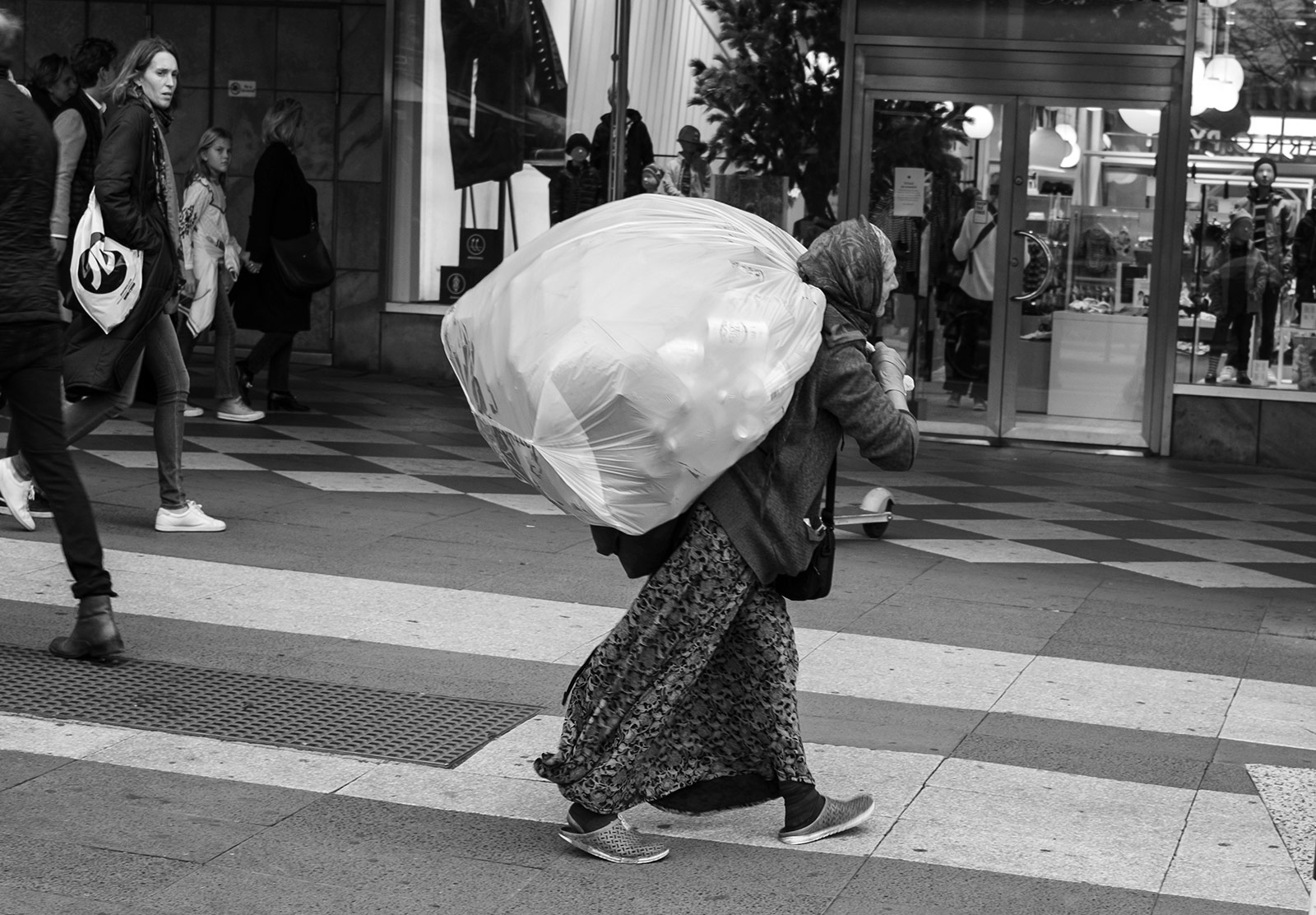 Lady carrying big bag of cans