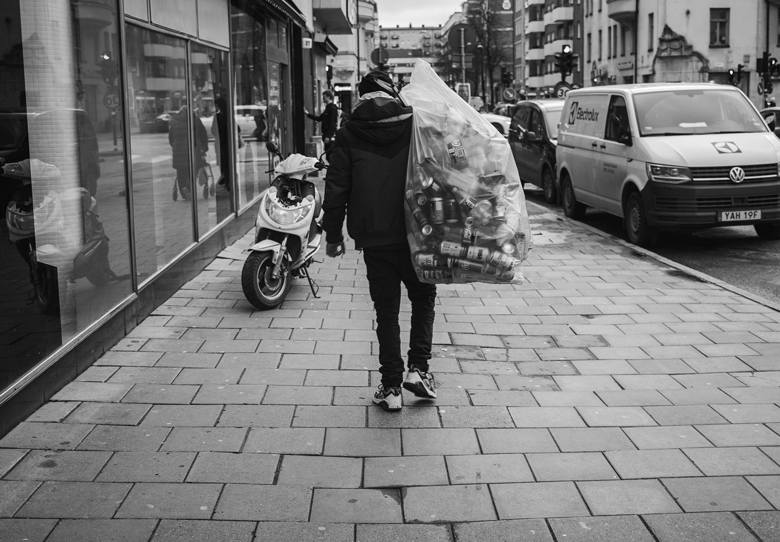 Man carrying bag of bottles and cans