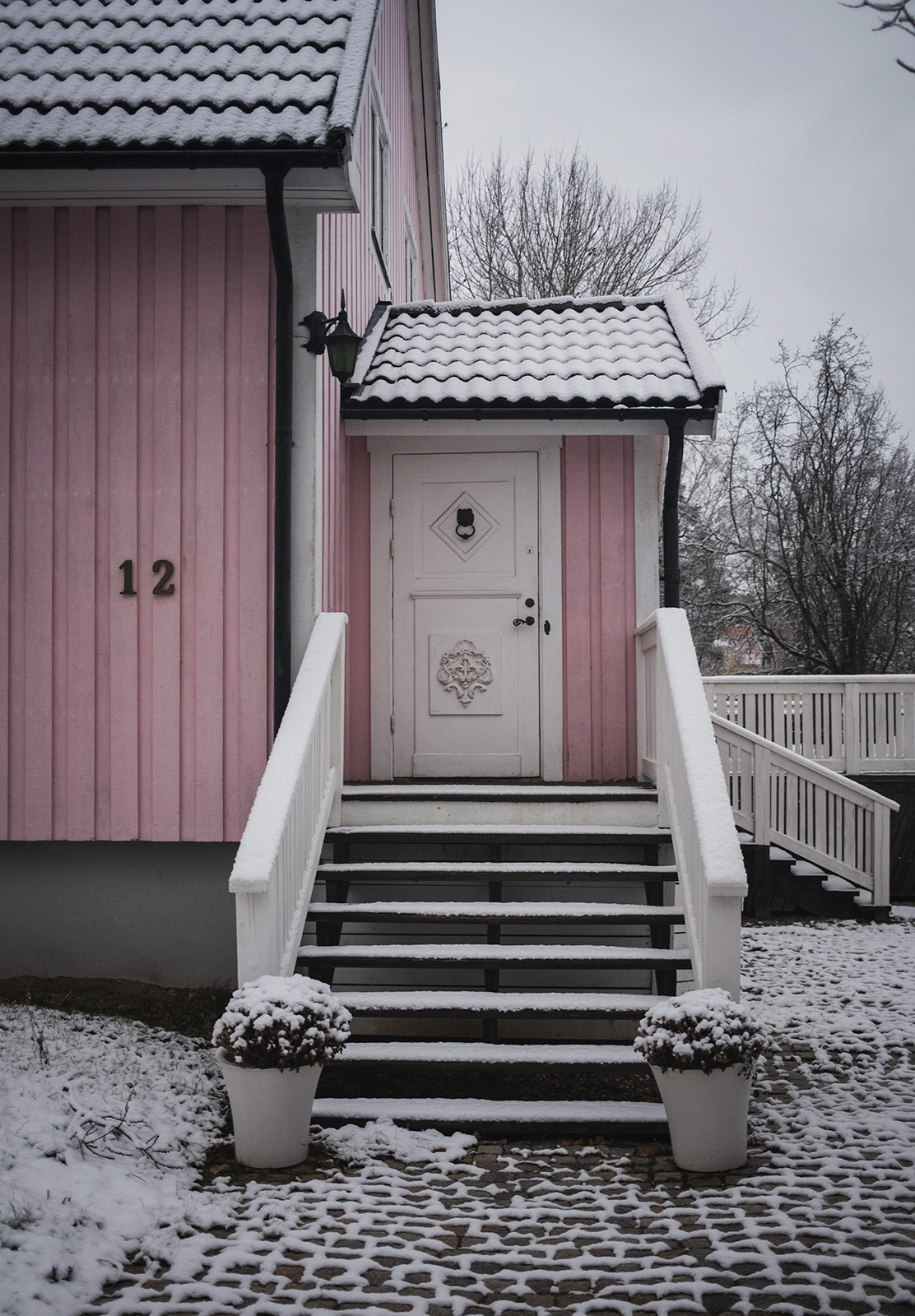 Door into pink wooden house