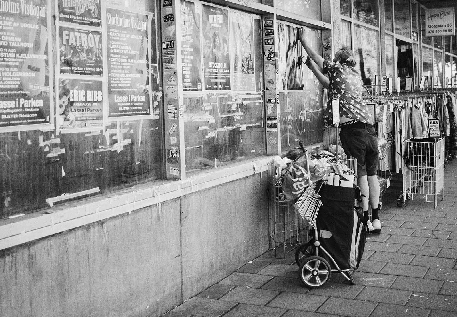 Man taping posters on a wall