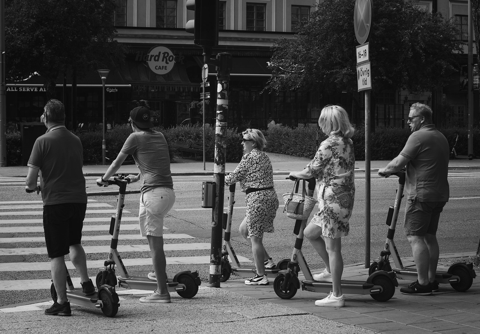 Group of people on scooter at a crossing