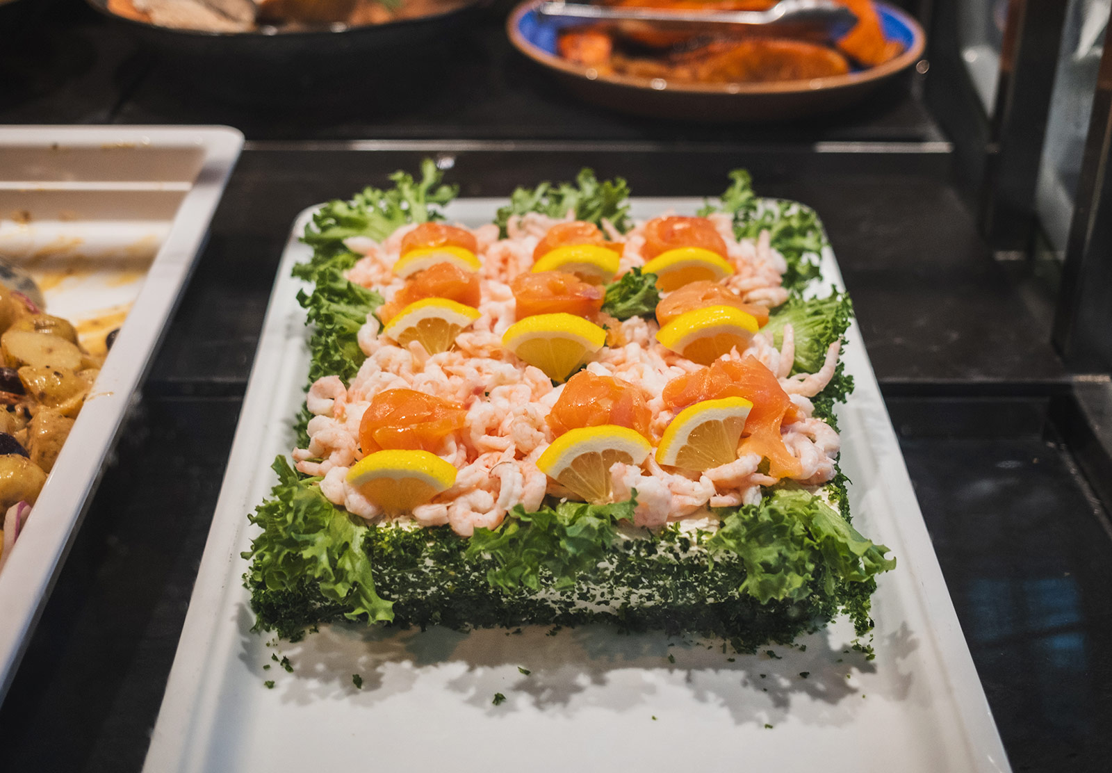 Sandwich covered in cream cheese, salmon and shrimp