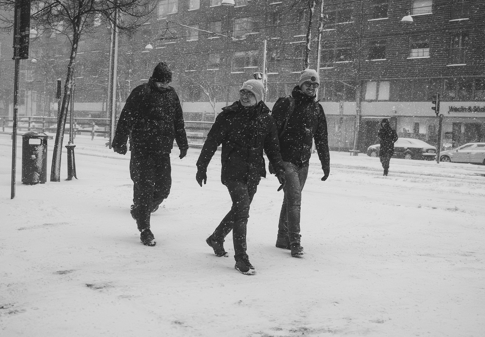 Three men smiling in the snow