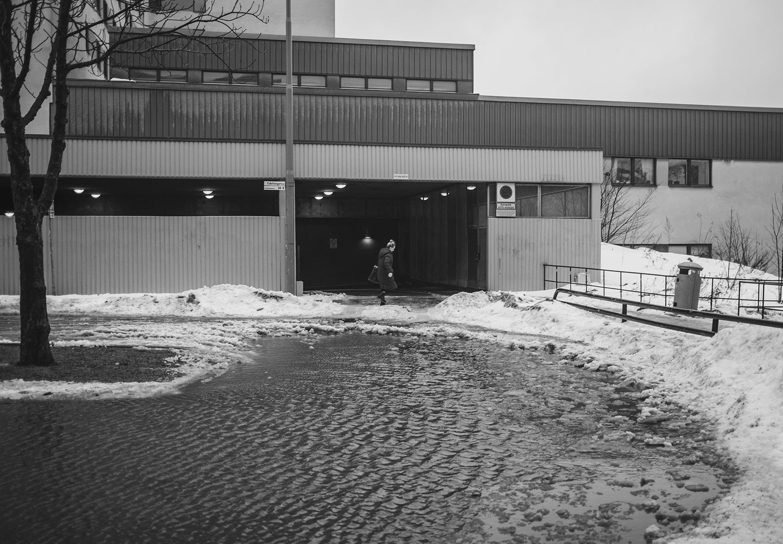 Woman passing deep puddle