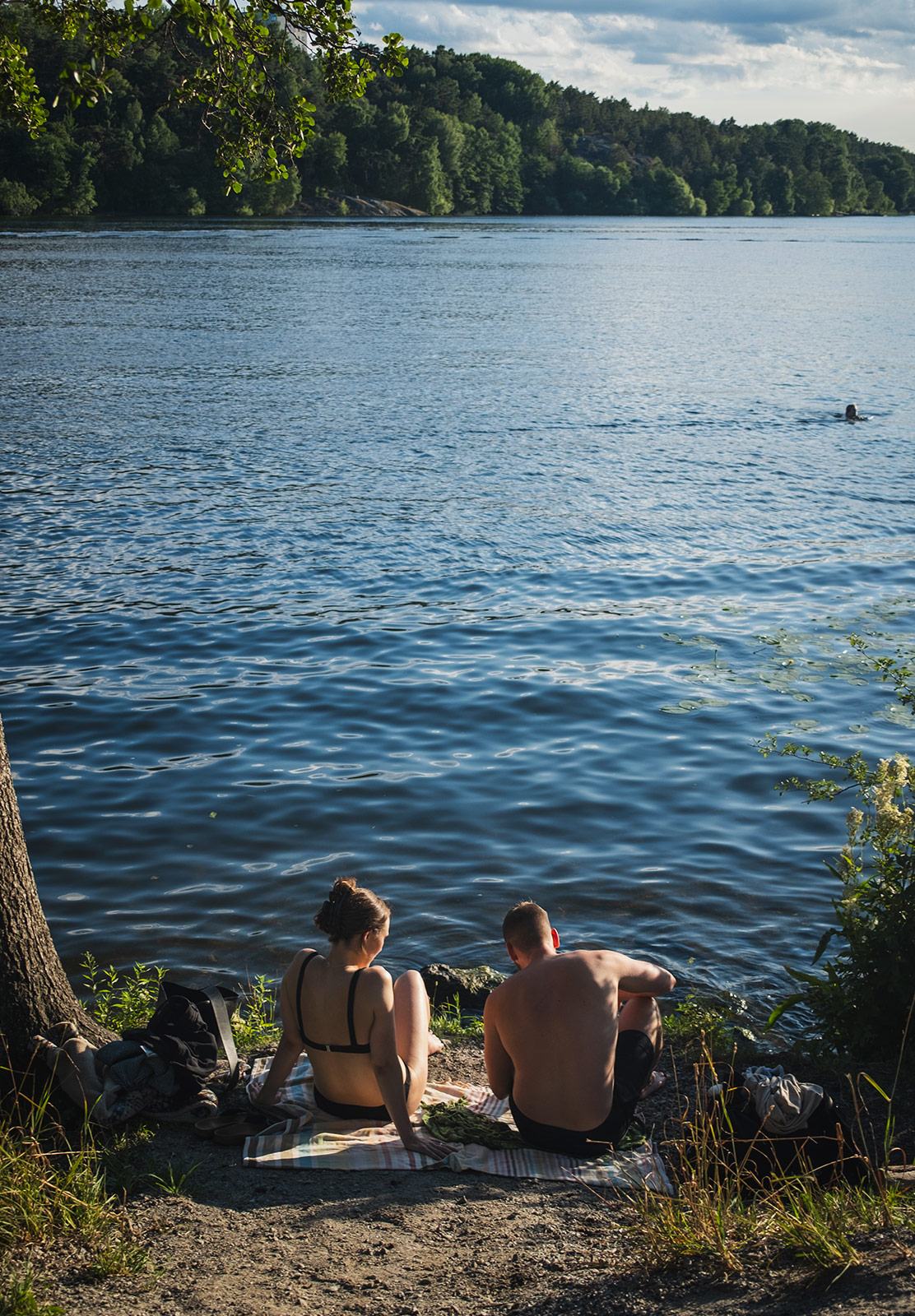 Couple sat by the water