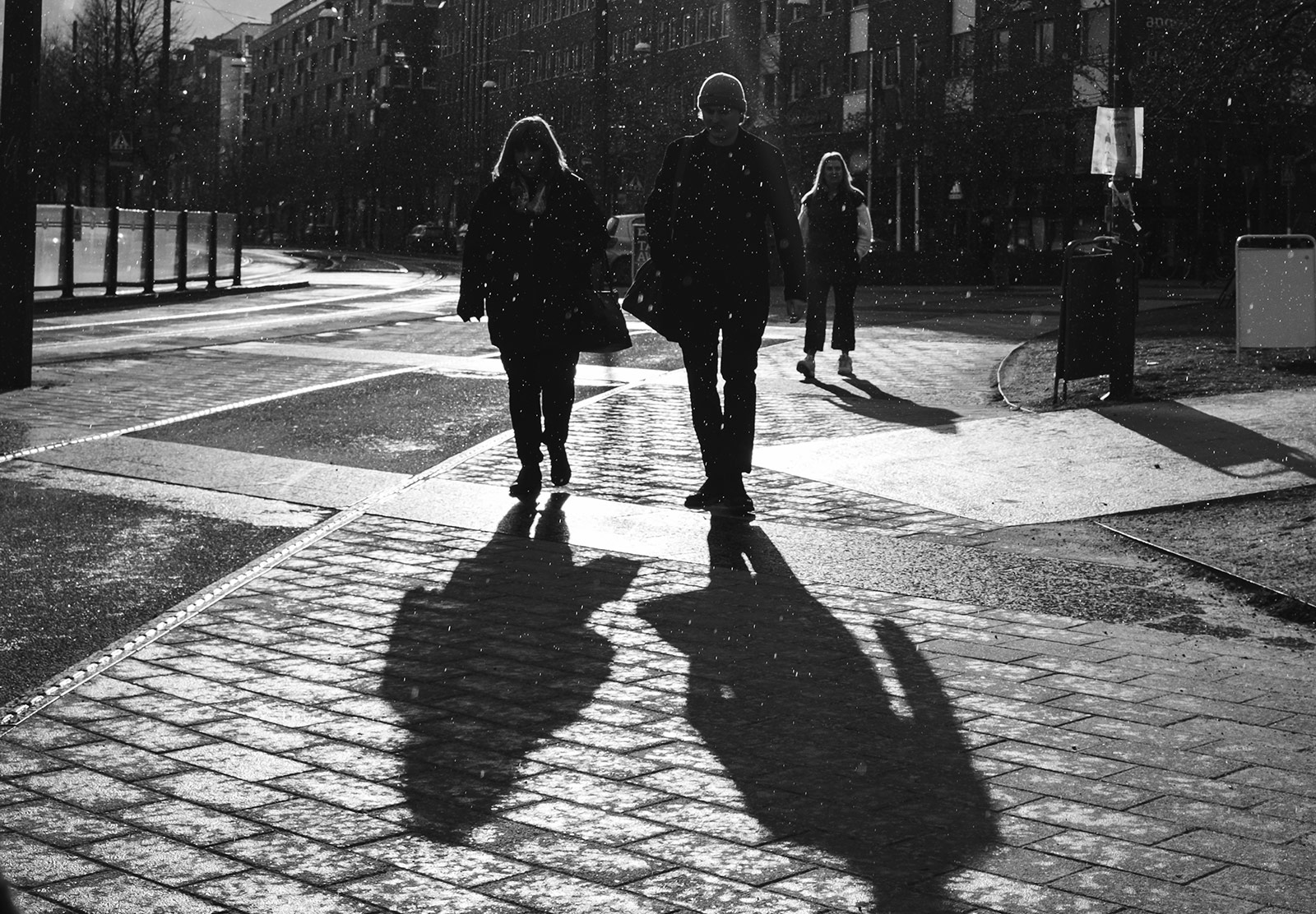 People walking in snow and sun