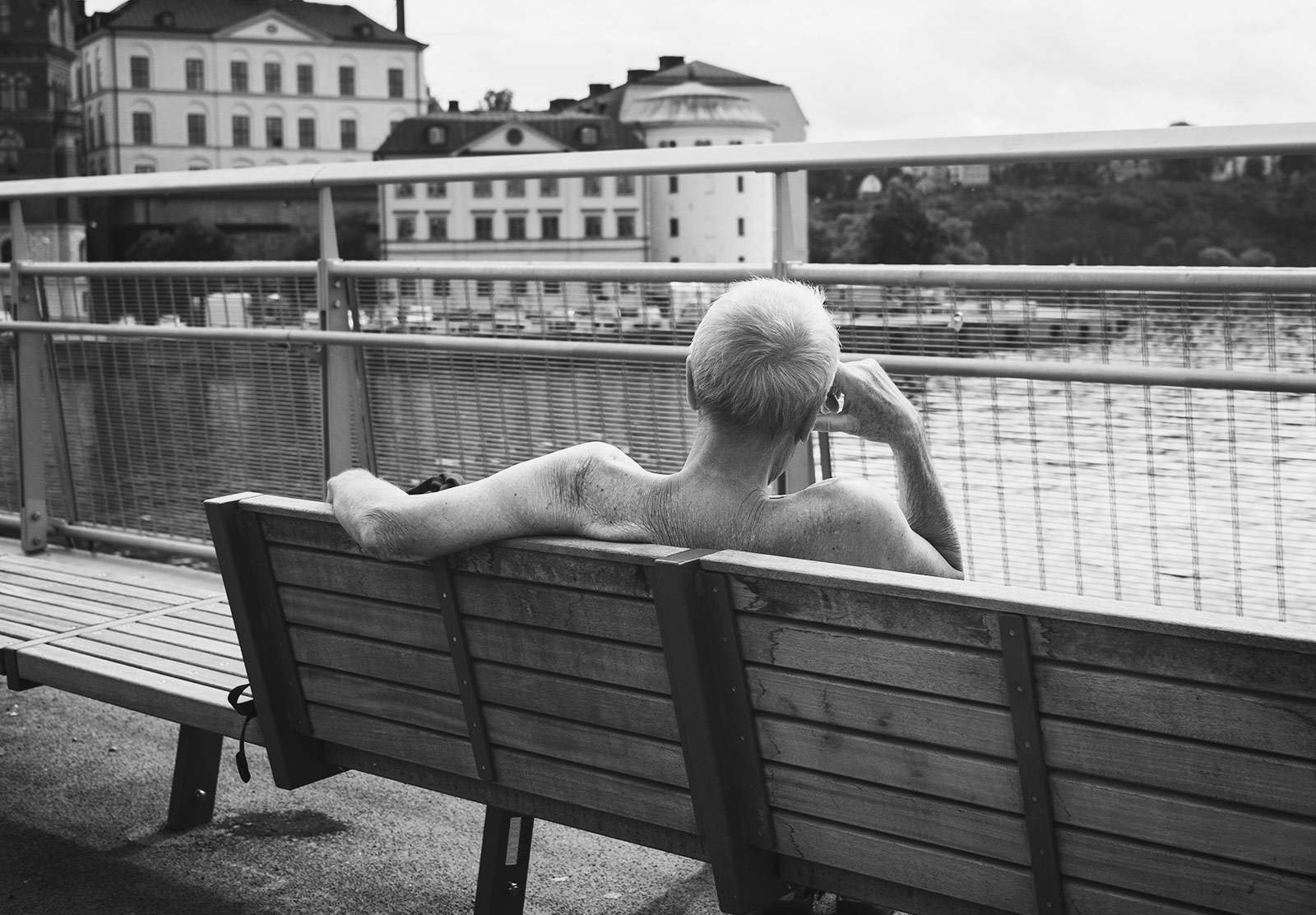 Man set on bench looking at water