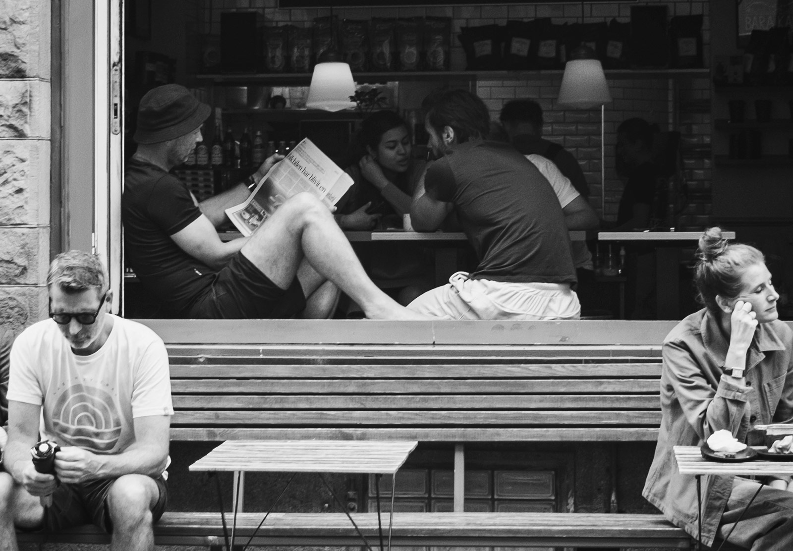 Man sat on café windowsill reading