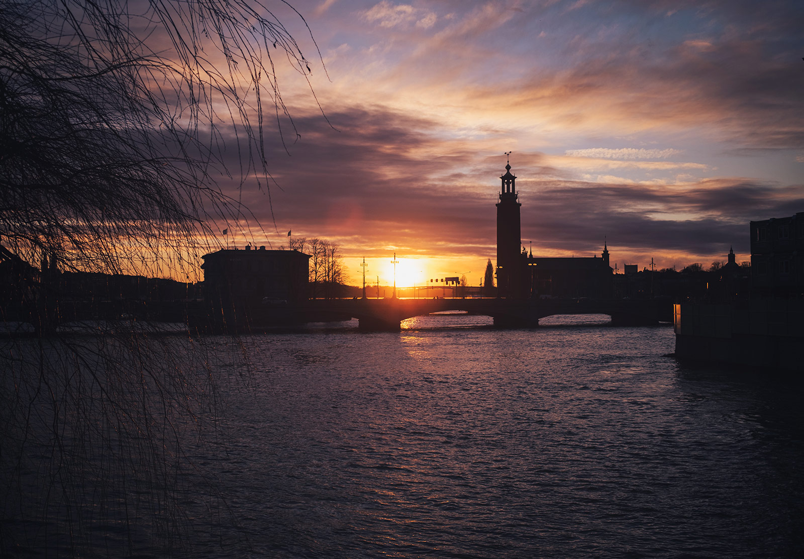 Sun setting behind buildings