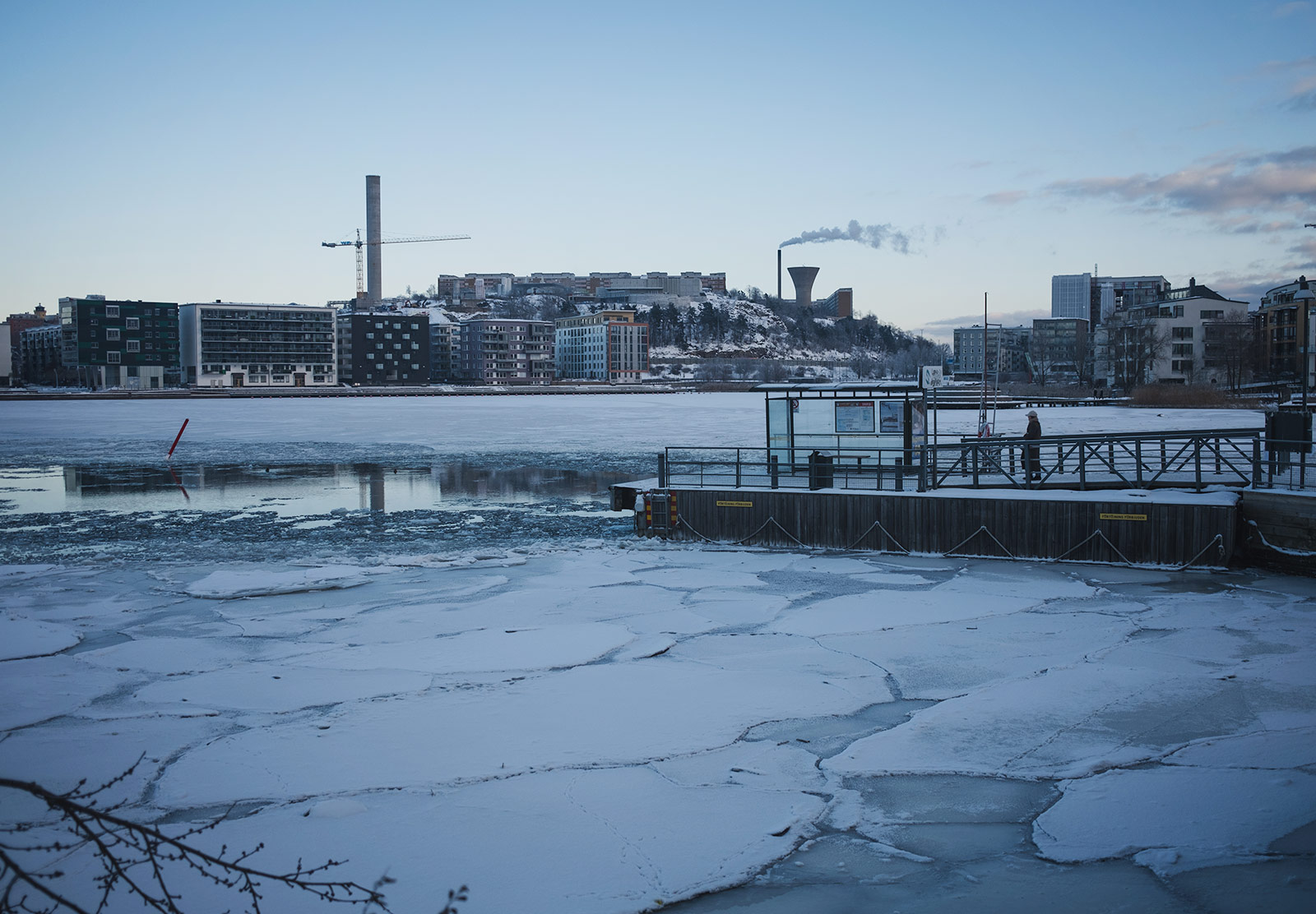 Wooden jetty resting on ice covered water