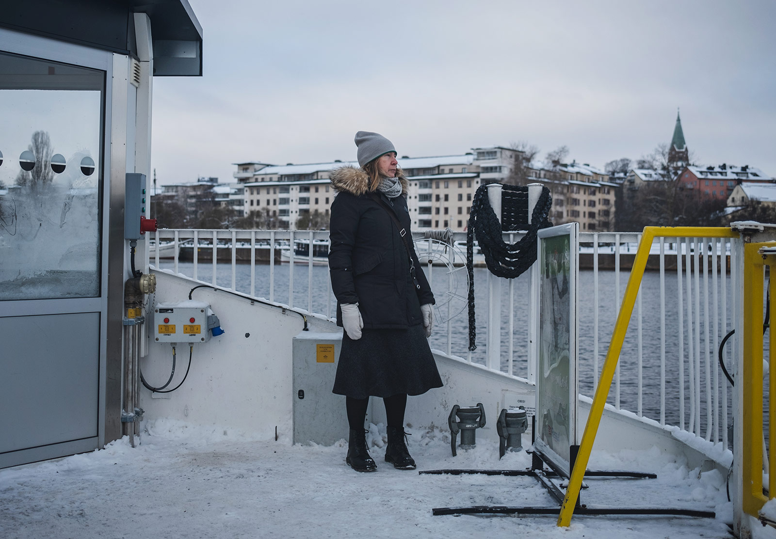 Woman standing on icy boat deck