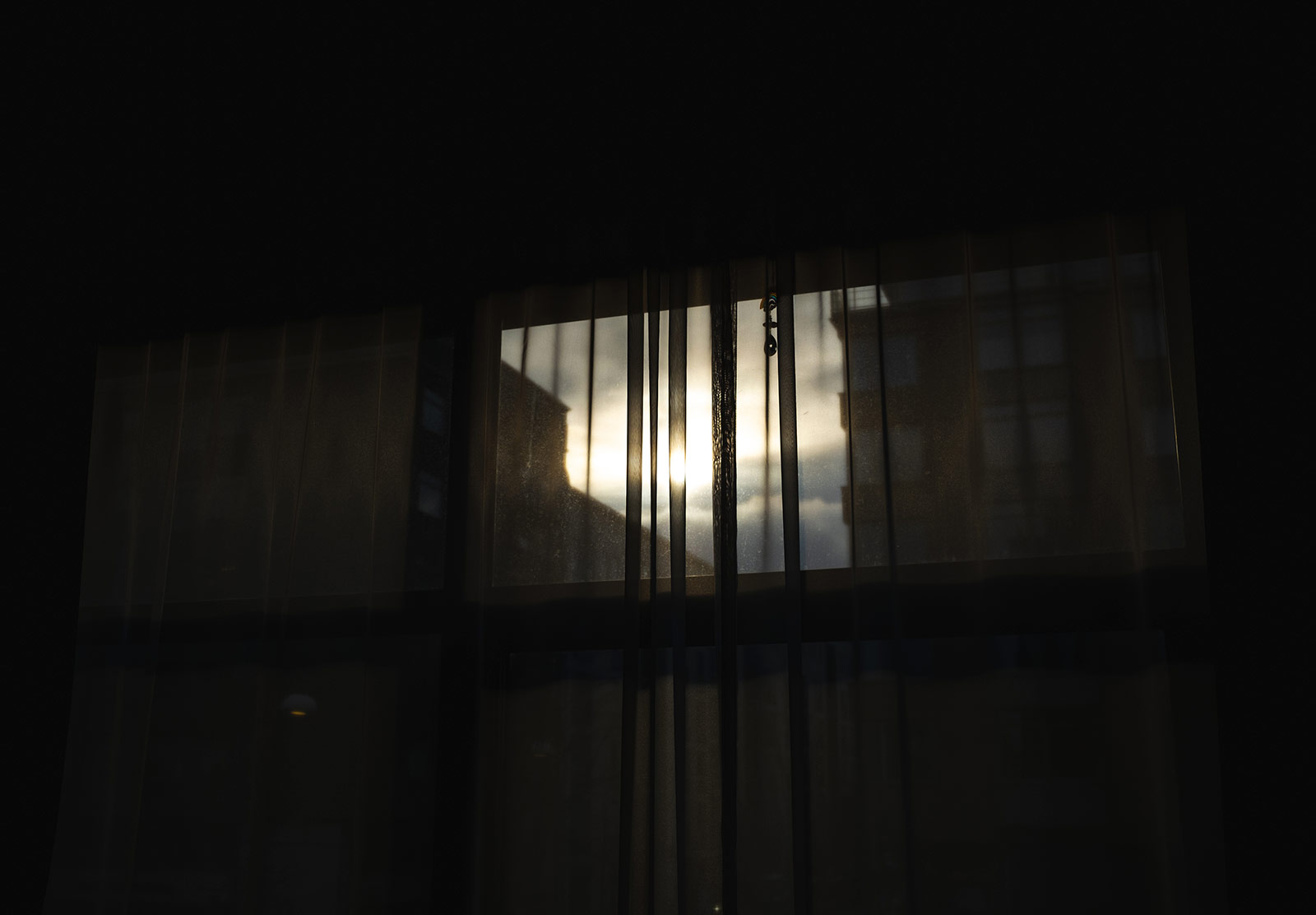 Sun shining through net curtains