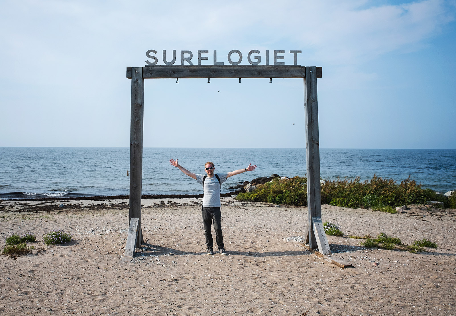 Man stood under sign