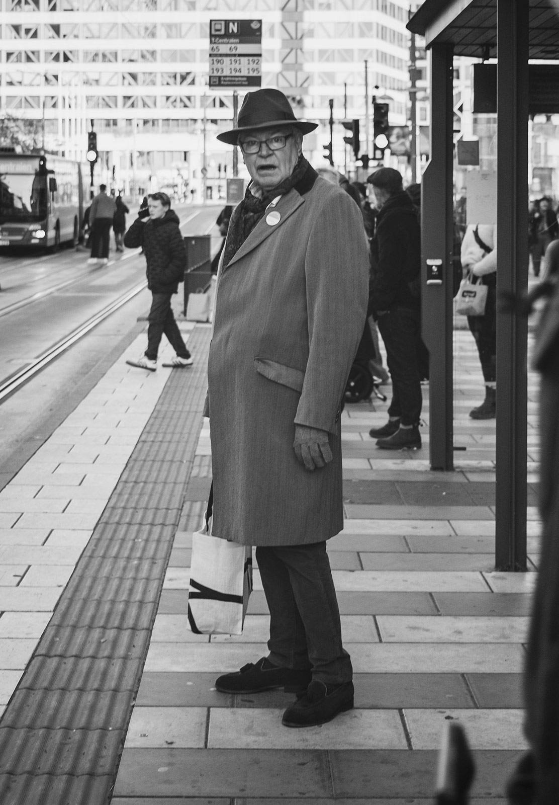Smartly dressed man at tram stop