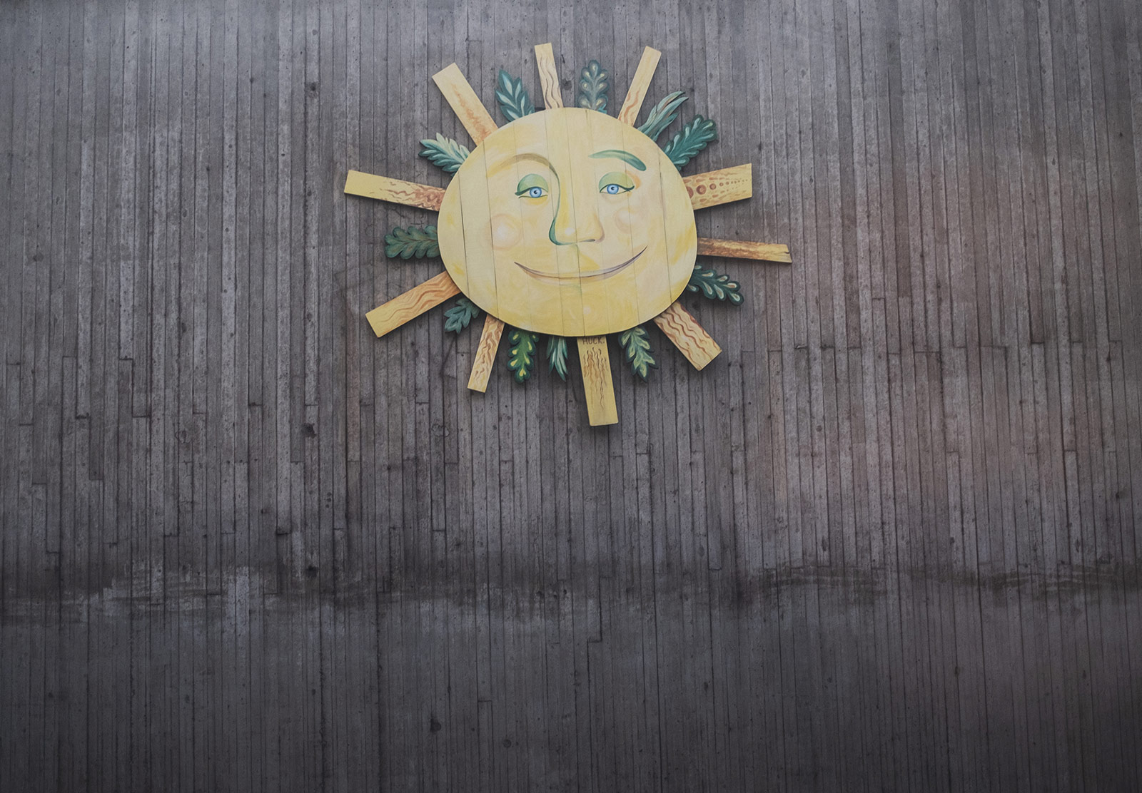 Sun emblem on a dull wall