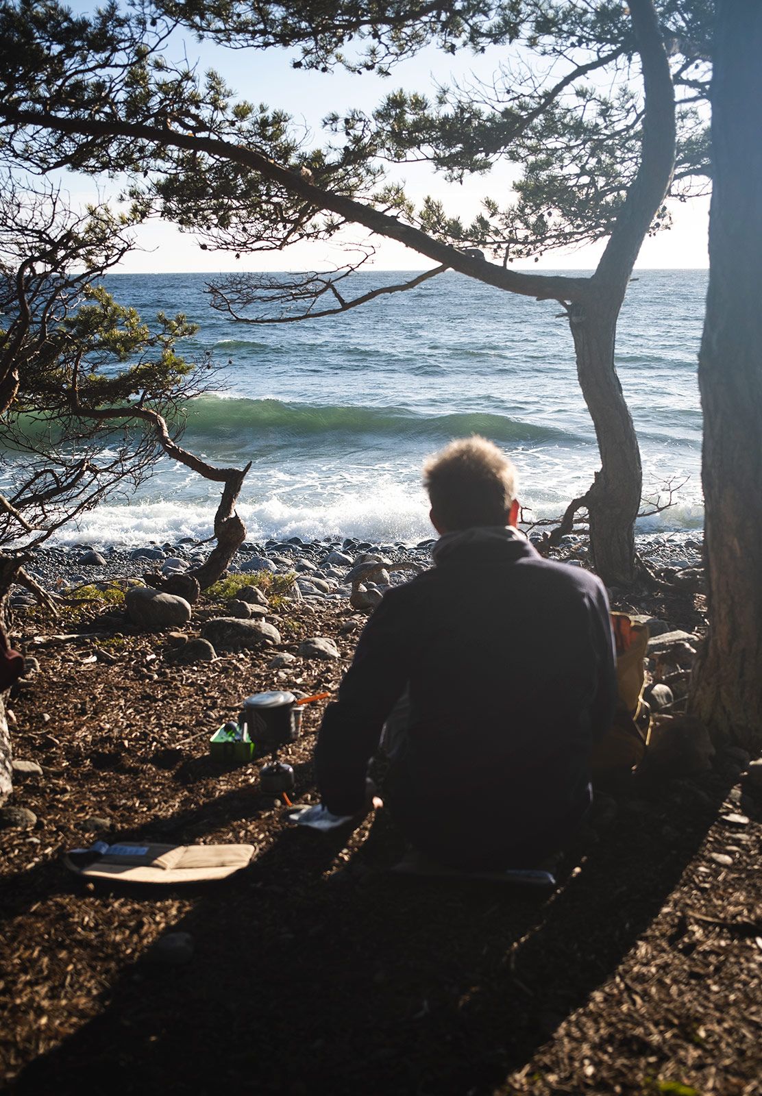 Man sat next to the sea