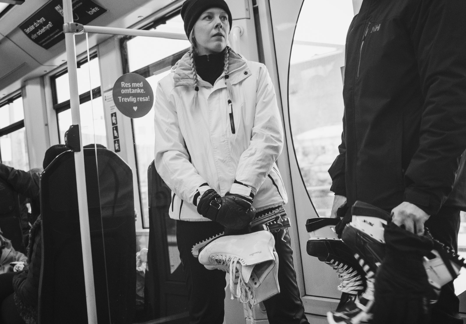 Couple holding ice skates on the tram