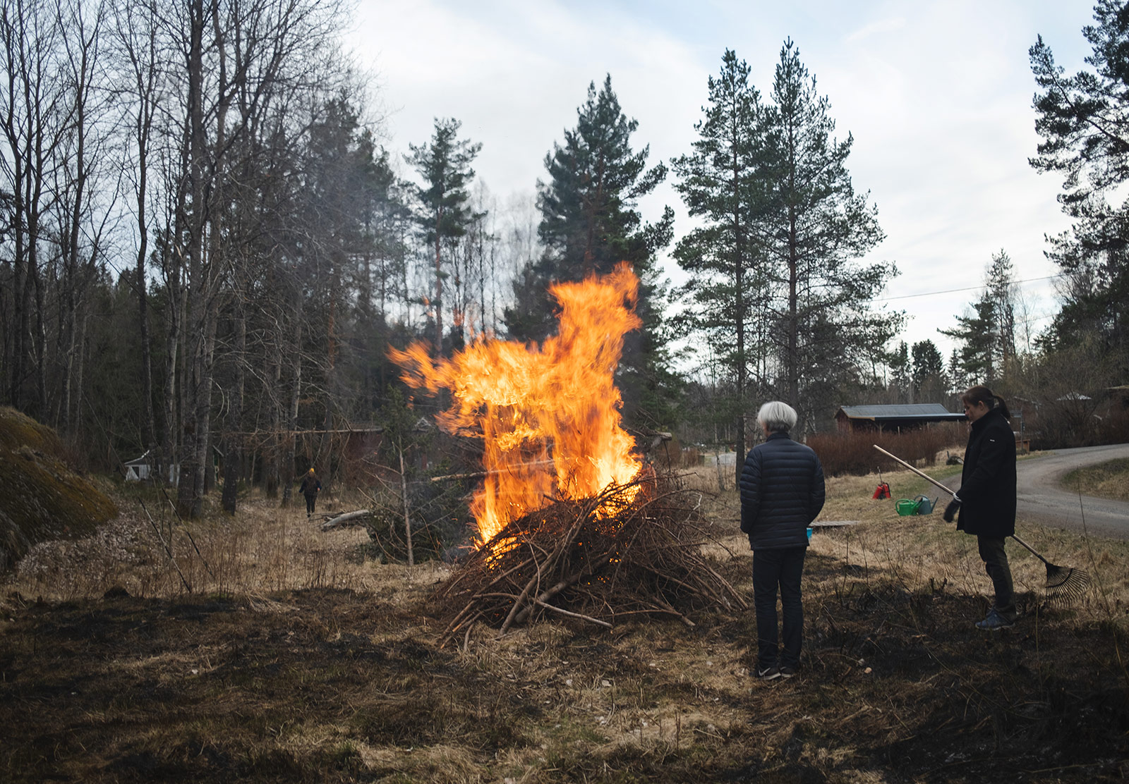 People standing next to bonfire