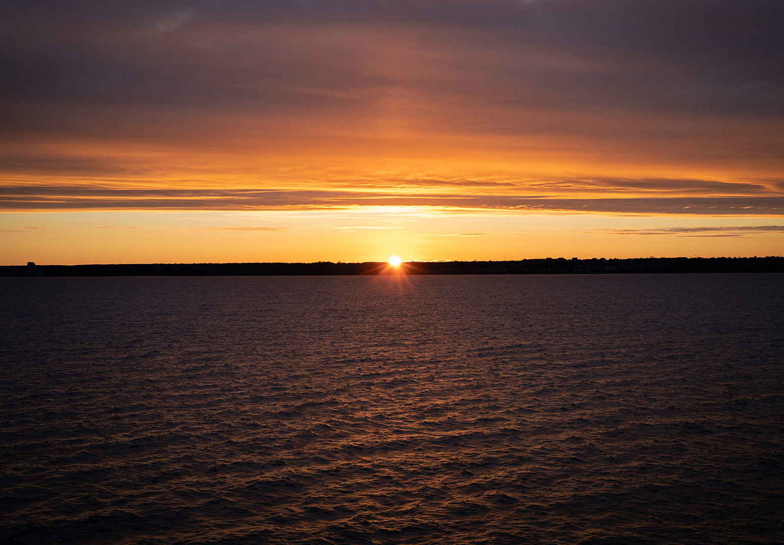 Sun rising over ocean