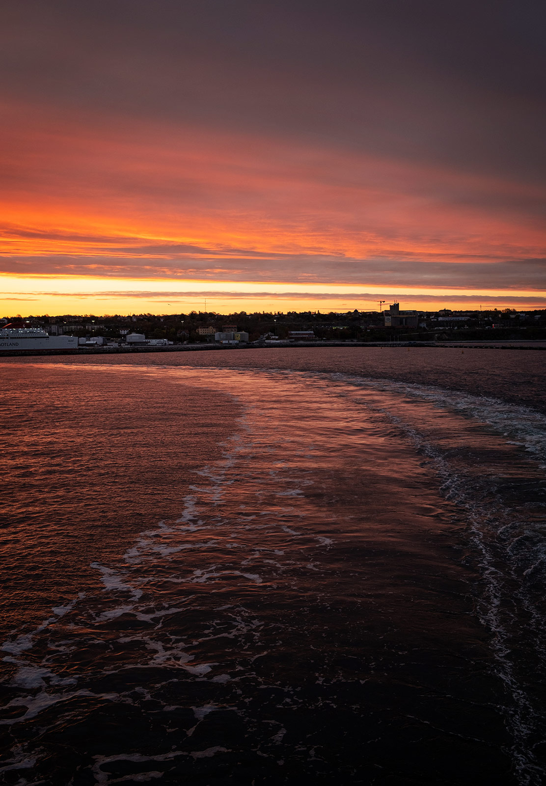 Pink sky over boat trails