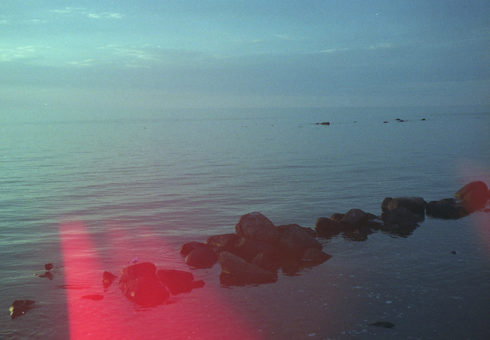 Rocks in ocean at dusk