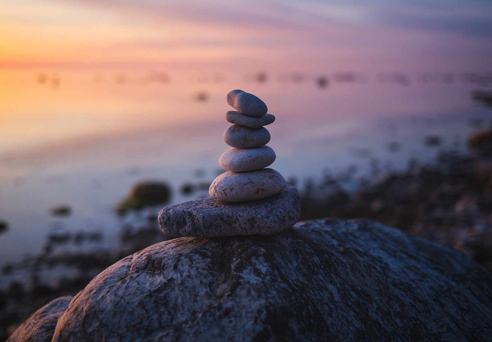 Pebble stack against sunset