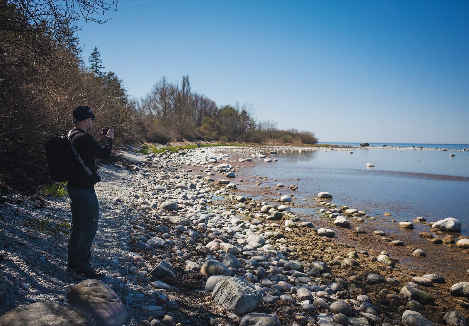 Man photographing coastline