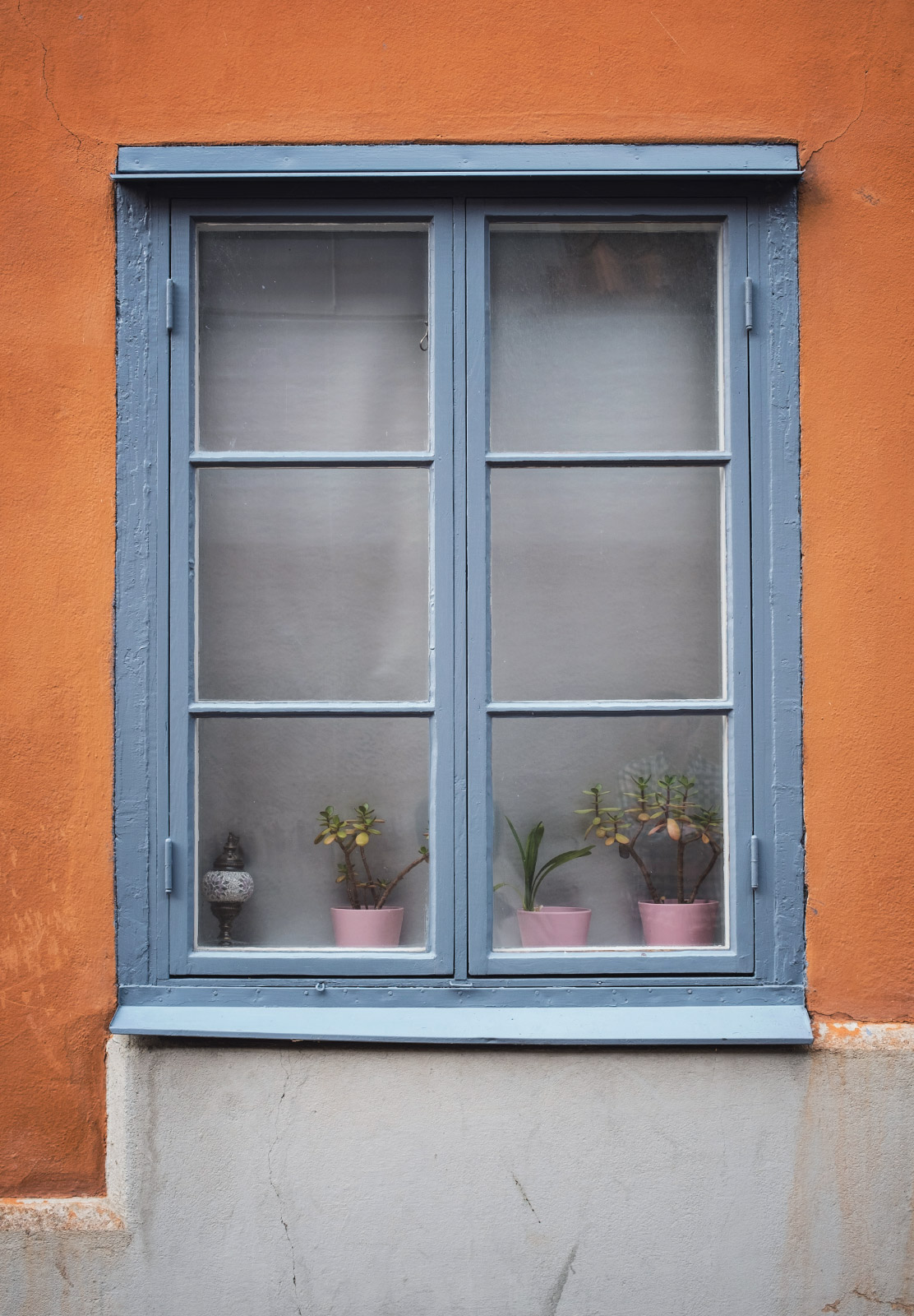 Blue window on orange wall