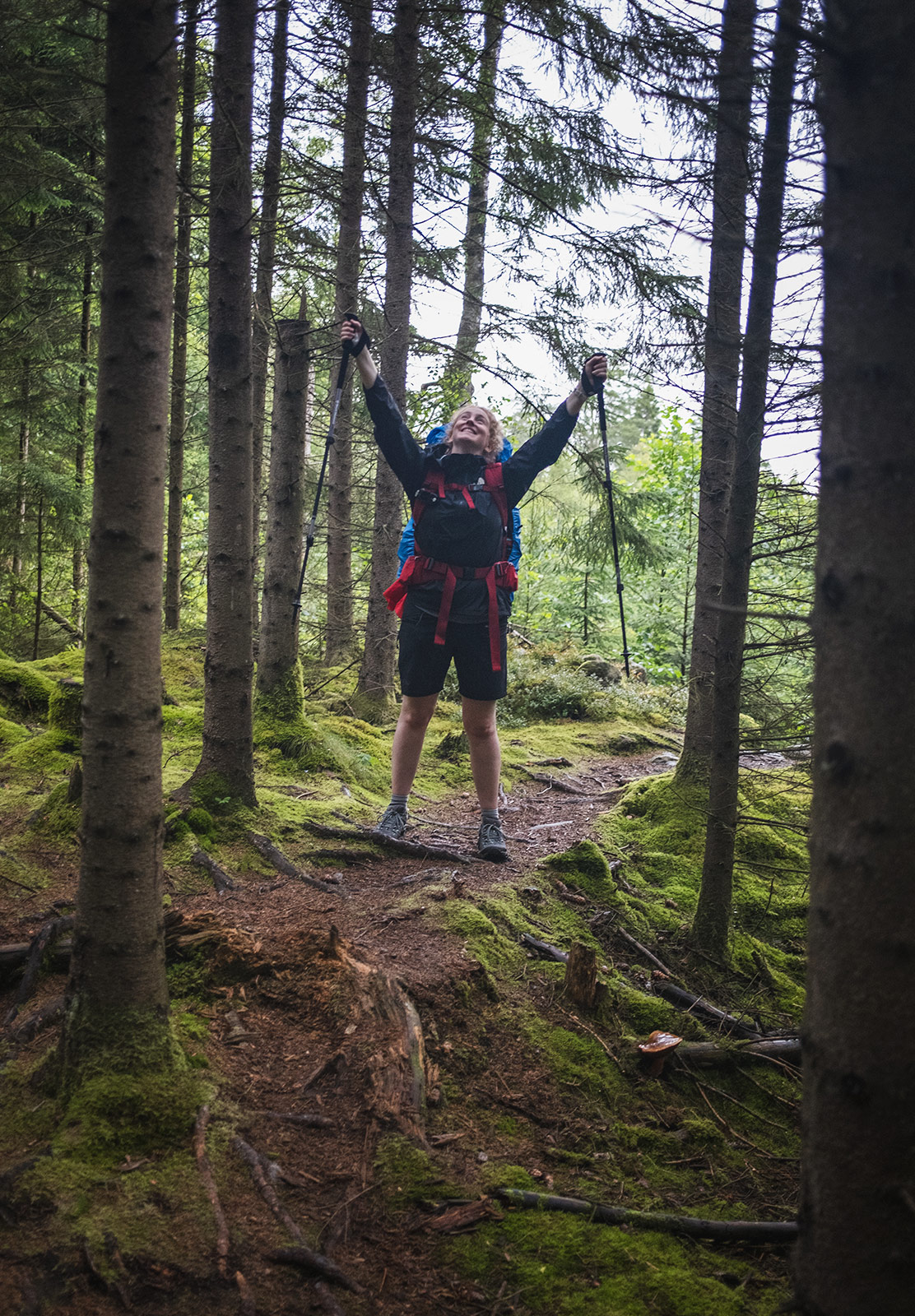 Woman standing on forest path