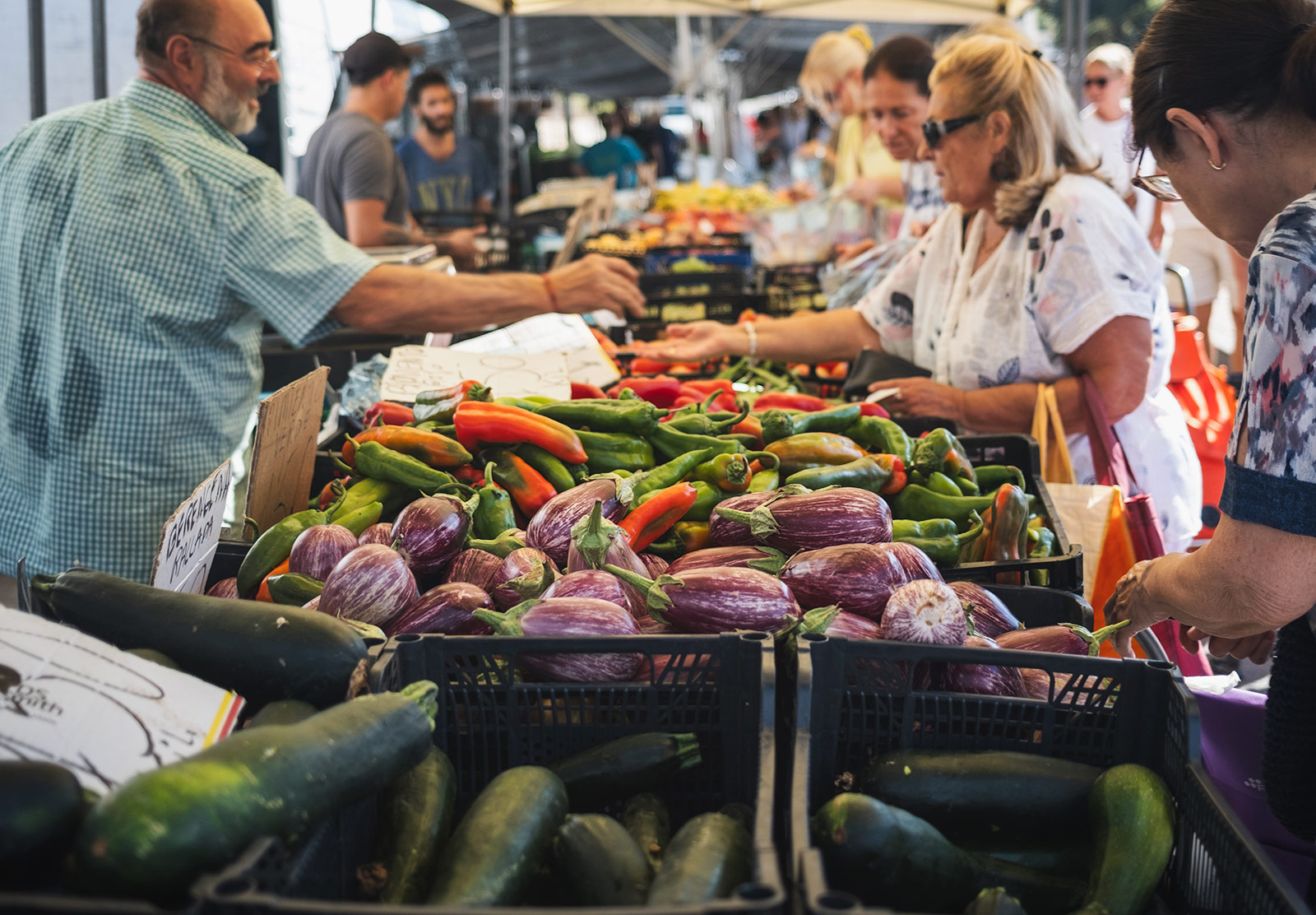 Piles of peppers and aubergines