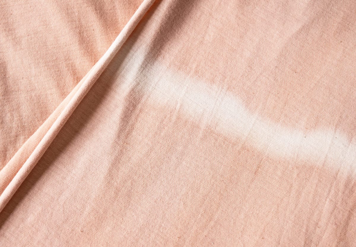 White stripe on pink fabric