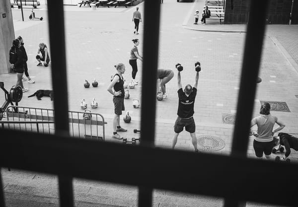 People lifting weights outdoors