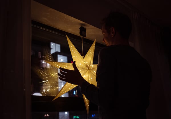 Man hanging paper star