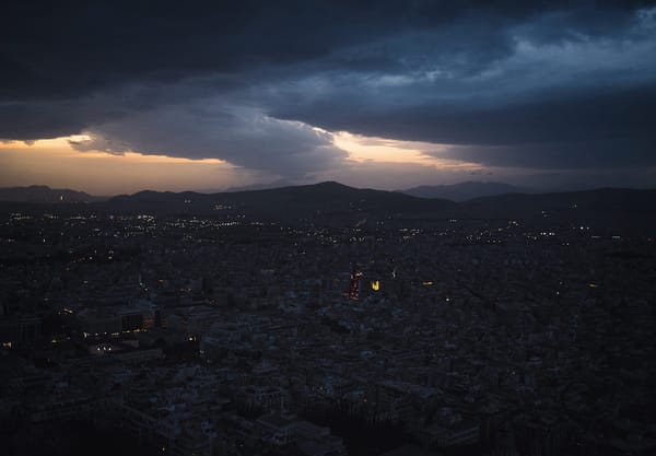 Dark moody sky over city, at sunset