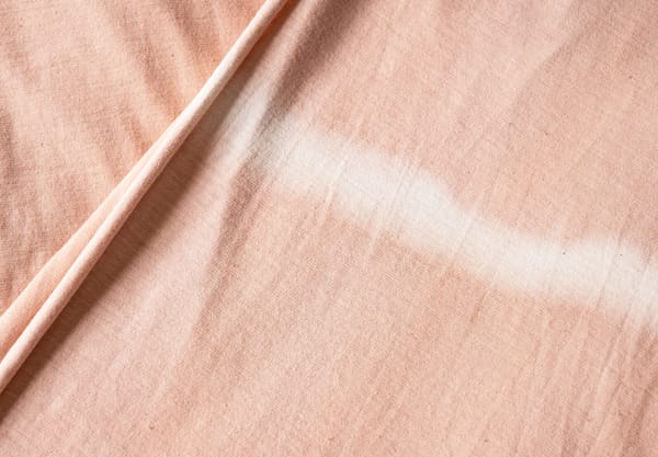 White stripe on pink fabric