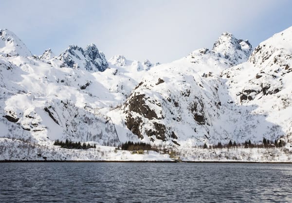 House at base of snowy mountain