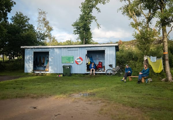Group of people sat outside wind shelter