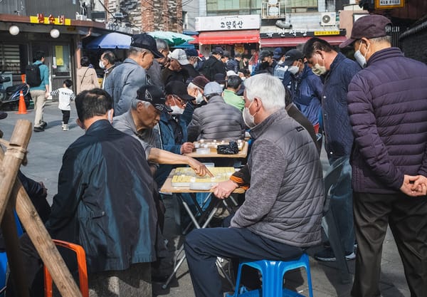 Man sitting at tables playing board games