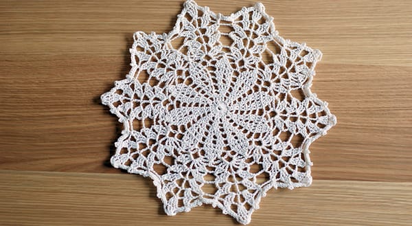 Crochet doily on wooden table