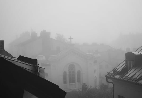 Church spire in fog